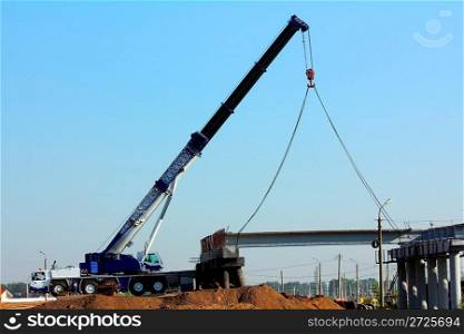 large automobile crane on the construction of overpass