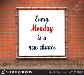 Large banner with inspirational quote on a brick wall - Every monday is a new chance