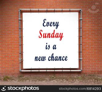 Large banner with inspirational quote on a brick wall - Every sunday is a new chance