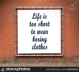 Large banner with inspirational quote on a brick wall - Life is to short to wear boring clothes