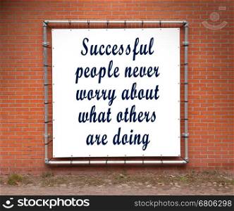 Large banner with inspirational quote on a brick wall - Successful people never worry...