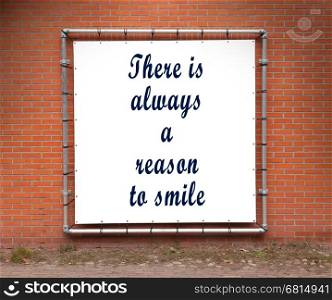 Large banner with inspirational quote on a brick wall - There is always a reason to smile