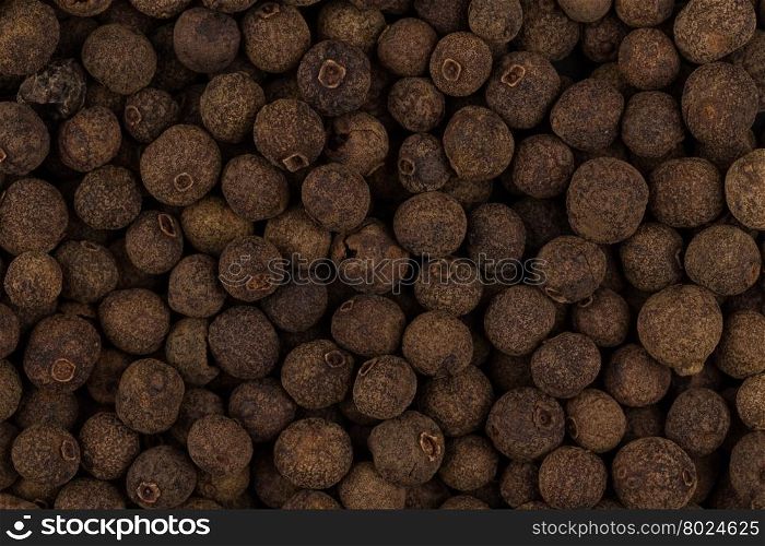 Large black pepper seeds corns as a background