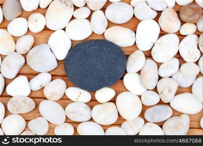 Large black stone surrounded by small white stones