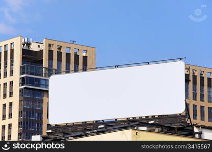 Large blank billboard on a building roof in the city downtown