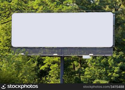 Large blank billboard with copy space in front of the green forest