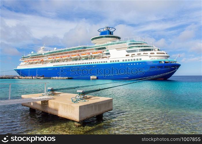 Large blue passenger ship anchored on coast of Bonaire