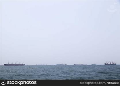 Large cargo ship Boats moored in the sea to make sense compared to the coast.
