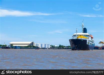 large cargo ship. Moored in the river. Large industrial port with freight.