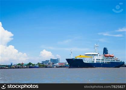 large cargo ship. Moored in the river. Space transportation industry.