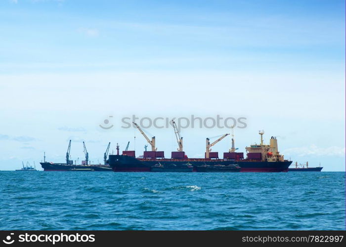 large cargo ship. Moored offshore. The import and export of goods waiting.