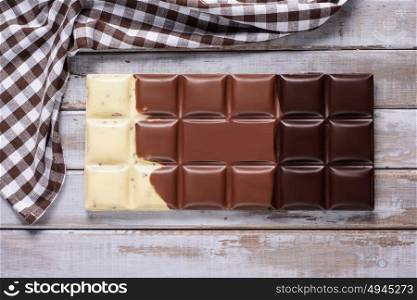 large chocolate bar on wooden background