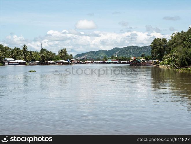 Large clear river which through the urban area along the mountain in the western of Thailand.