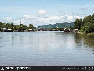 Large clear river which through the urban area along the mountain in the western of Thailand.