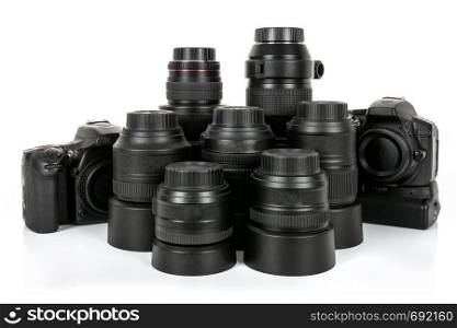 Large collection of professional and modern lenses and DSLR cameras isolated on a white background.