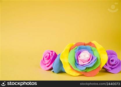 large creative beautiful rose made with clay yellow background