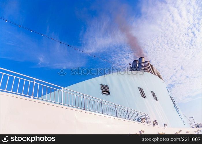 large cruise ship pollutes the atmosphere - smoke from pipe. cruise ship pollutes the atmosphere