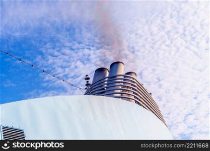 large cruise ship pollutes the atmosphere - smoke from pipe. cruise ship pollutes the atmosphere