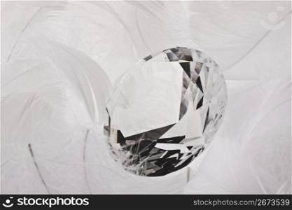 Large diamond wrapped in white feathers