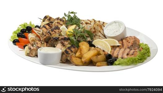 Large dish with seafood on the grill on an isolated background. Large dish with seafood on the grill
