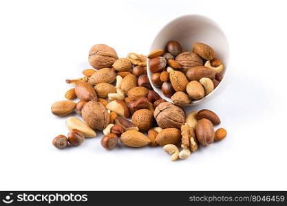 Large diversity of healthy nuts in a white bowl - isolated