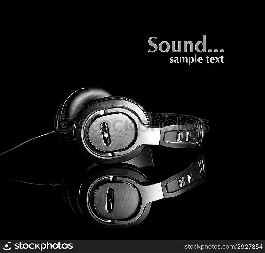 Large earphones isolated in black background