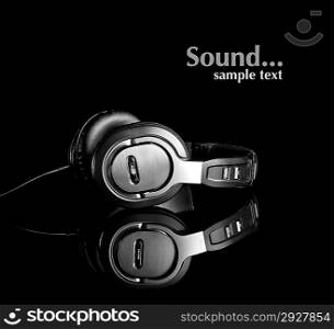 Large earphones isolated in black background
