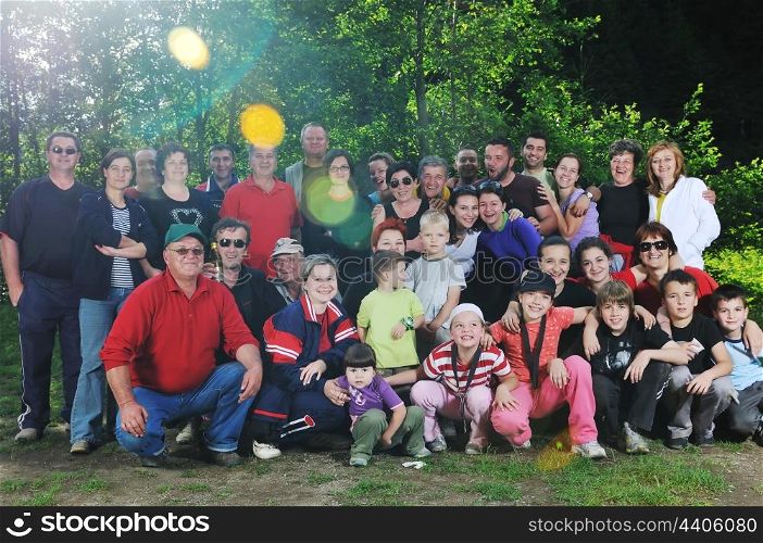 large family group portrait outdoor in nature at beautiful summer day
