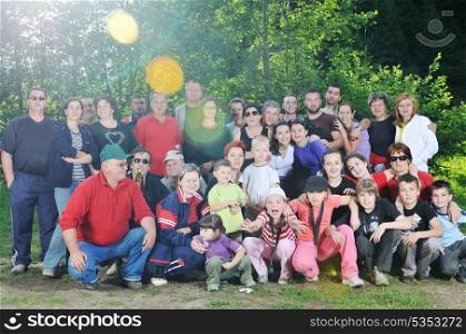 large family group portrait outdoor in nature at beautiful summer day