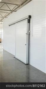 large freezer storage in the factory. closed door from warehouse. warehouse freezer in the factory