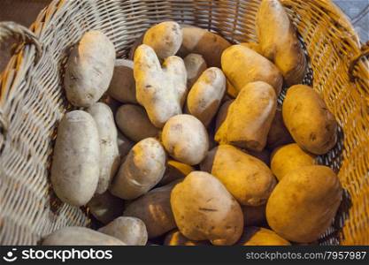 Large fresh potato in a beautiful basket basket. Large fresh potato in a beautiful basket basket.