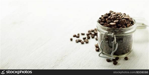 Large glass jar full of coffee beans