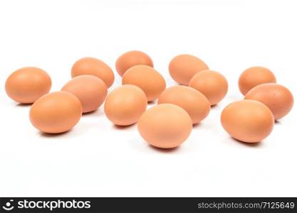 Large group of brown eggs isolated on a white background.