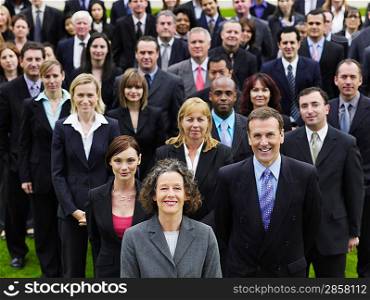 Large group of business people standing on lawn, portrait, elevated view