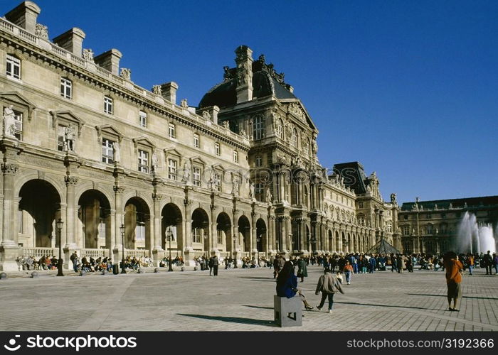 Large group of people gathered outside Lovre Museum Paris, France