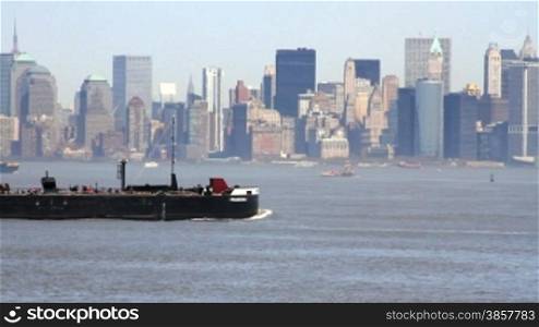 Large industrial ship passing in front Manhattan