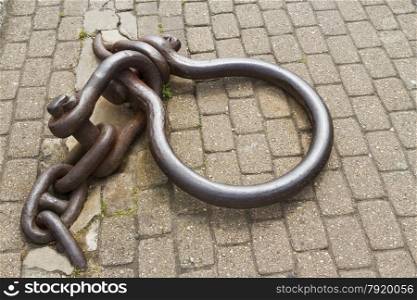 Large iron mooring ring and chain. Weymouth harbour, Dorset, England, United Kingdom