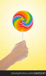 Large lollipop on stick on color background