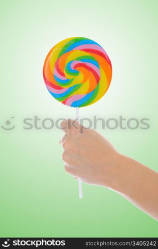 Large lollipop on stick on color background