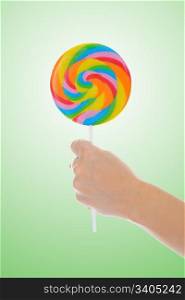 Large lollipop on stick on color background
