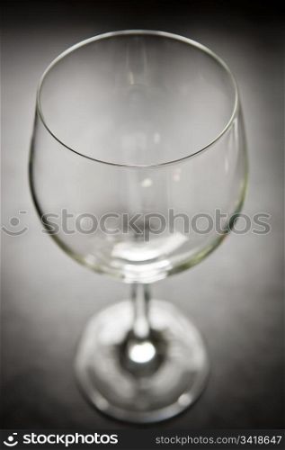 Large modern wine glass from above sits on bench top