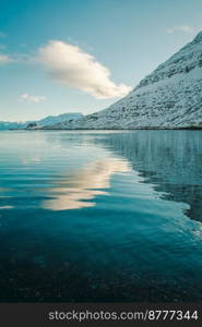 Large mountain slope on sea coast landscape photo. Beautiful nature scenery photography with sky on background. Idyllic scene. High quality picture for wallpaper, travel blog, magazine, article. Large mountain slope on sea coast landscape photo