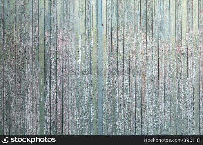 large old barn doors with peeling green paint