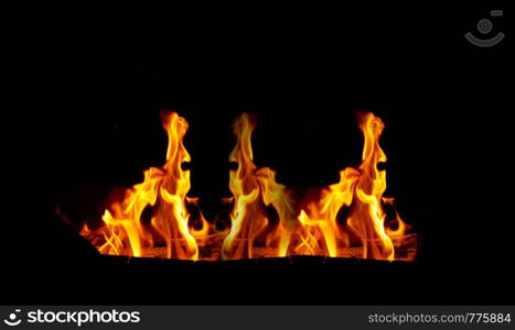 large orange flame on a black background, close up