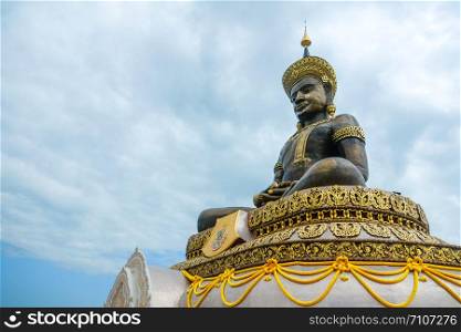 Large outdoor bronze statue of Buddha Maha Thammaracha at Wat Traiphum temple. Phetchabun, Thailand.