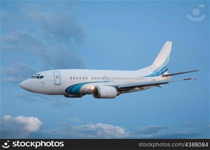 Large passenger plane flying in the blue sky