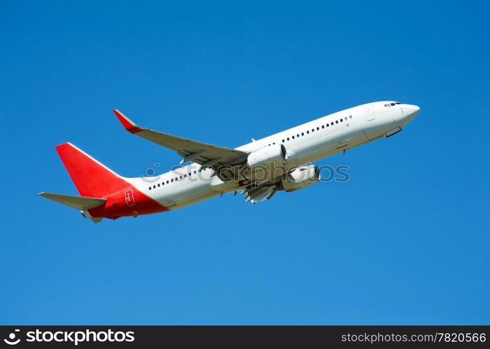 Large passenger plane flying in the blue sky