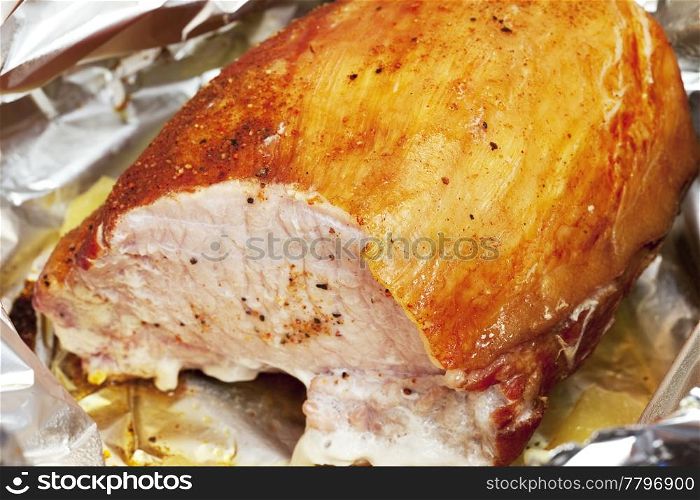 large piece of meat in foil with spices