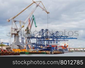 Large port cranes on a pier in the port of Gdynia.. Gdynia. Sea port.