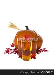 Large pumpkin with drinks and red maple leafs on white background